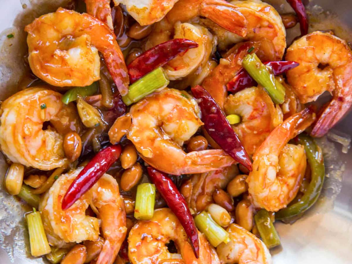 Stir-fried shrimp, chilies, peanuts and sauce in wok.