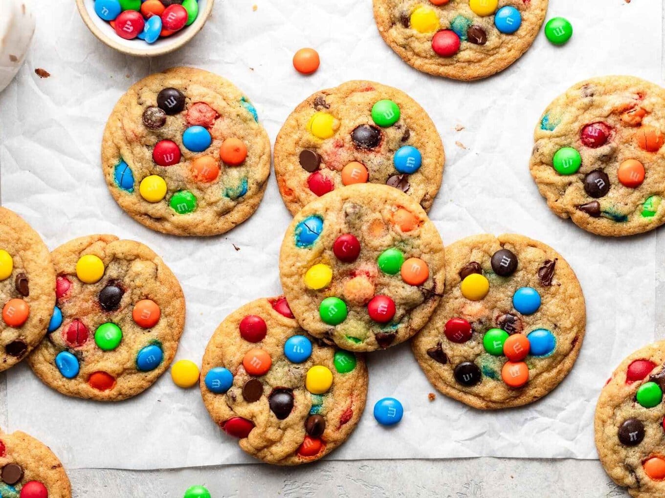 M&M Cookies are soft, chewy, and PERFECT for making ahead of time, made with M&M candies and chocolate chips, and bake in only 10 minutes! A perfect kid-friendly Christmas holiday baking dessert! Cookies on baking sheet