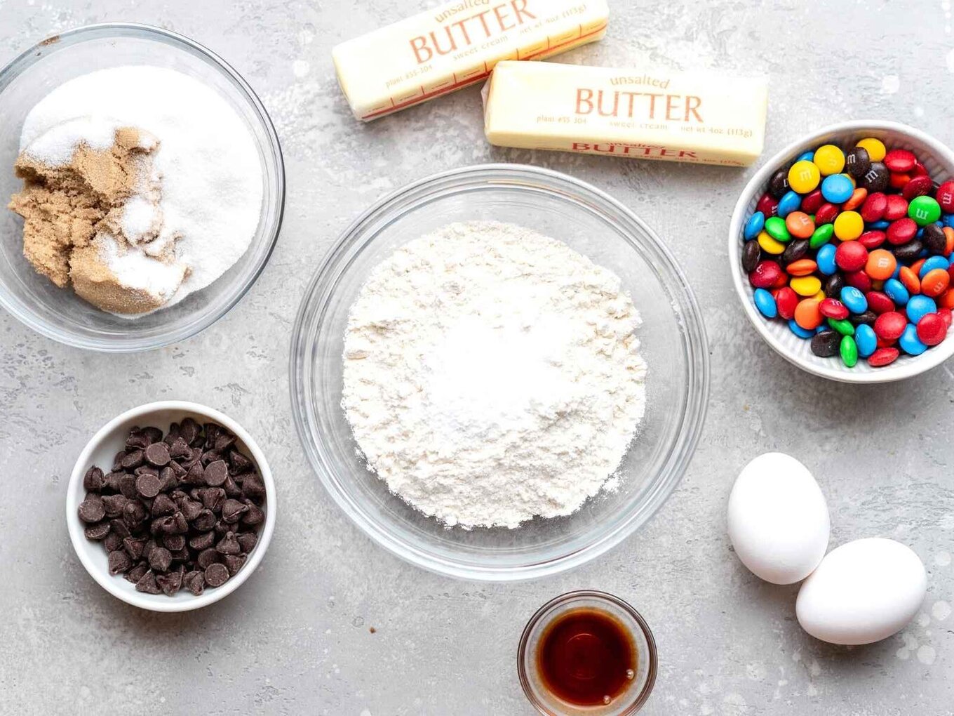 M&M Cookies are soft, chewy, and PERFECT for making ahead of time, made with M&M candies and chocolate chips, and bake in only 10 minutes! A perfect kid-friendly Christmas holiday baking dessert! ingredients for cookies in mixing bowls