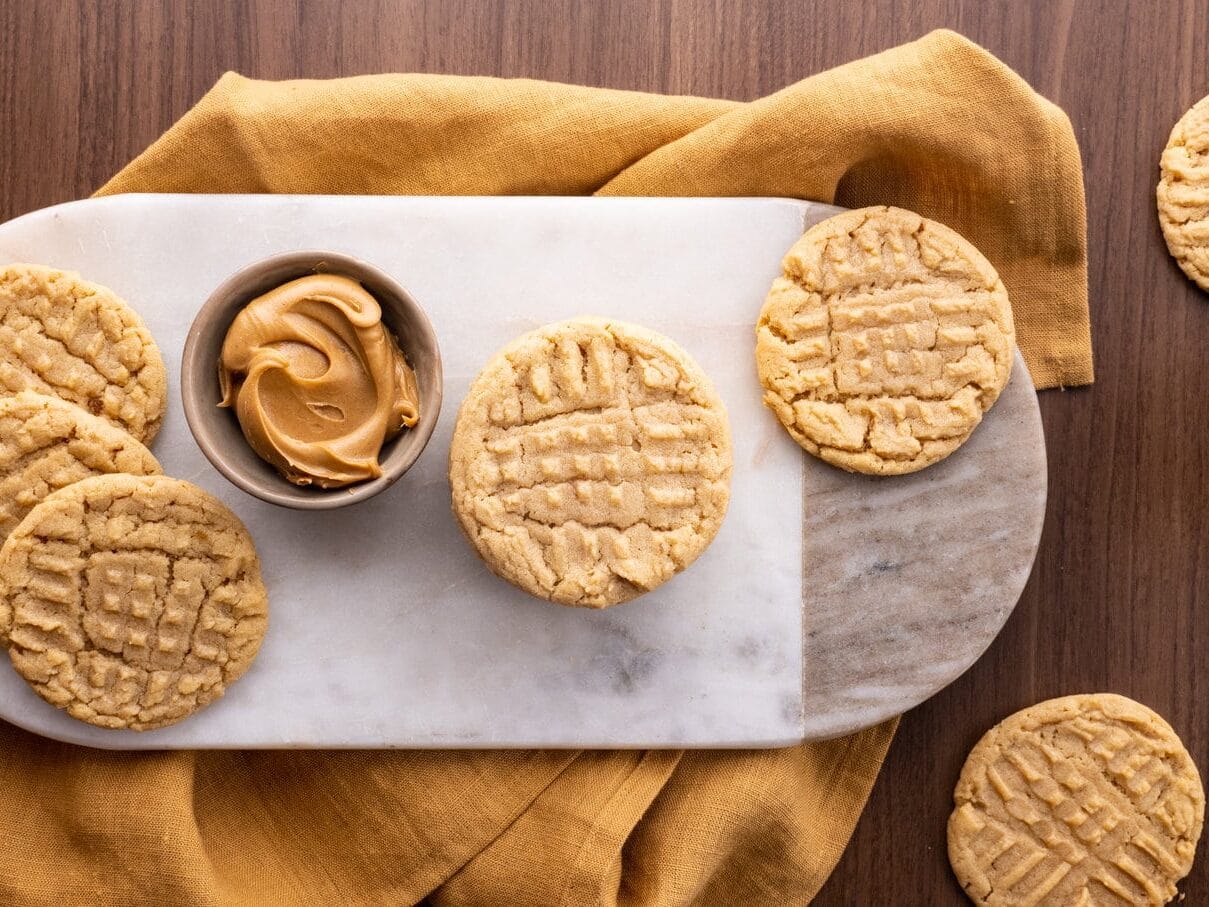 cookies and a ramkin of peanut butter on serving plate