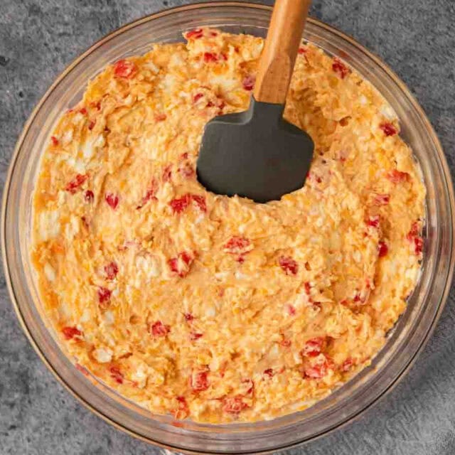 Bowl of cheese mixture combined with spatula