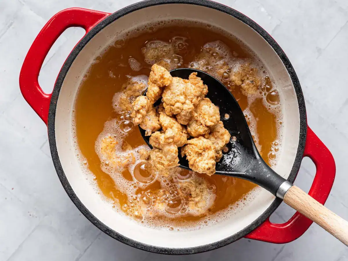 Shrimp frying in oil with spoon