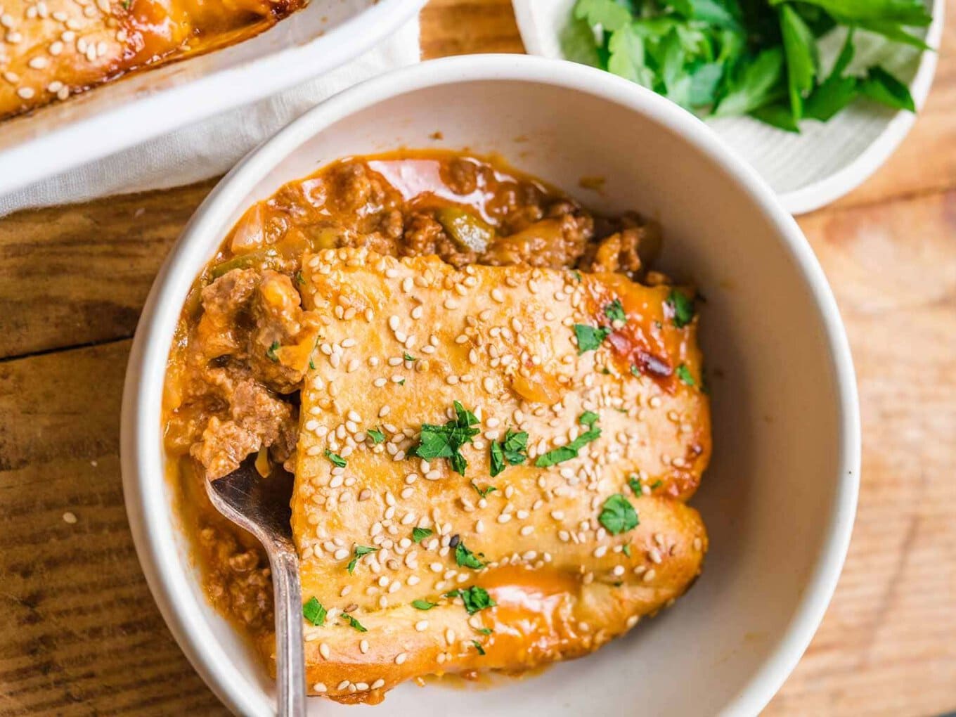 Casserole in a white bowl with a fork