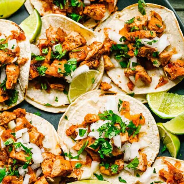 Street Tacos with lime wedges on a platter