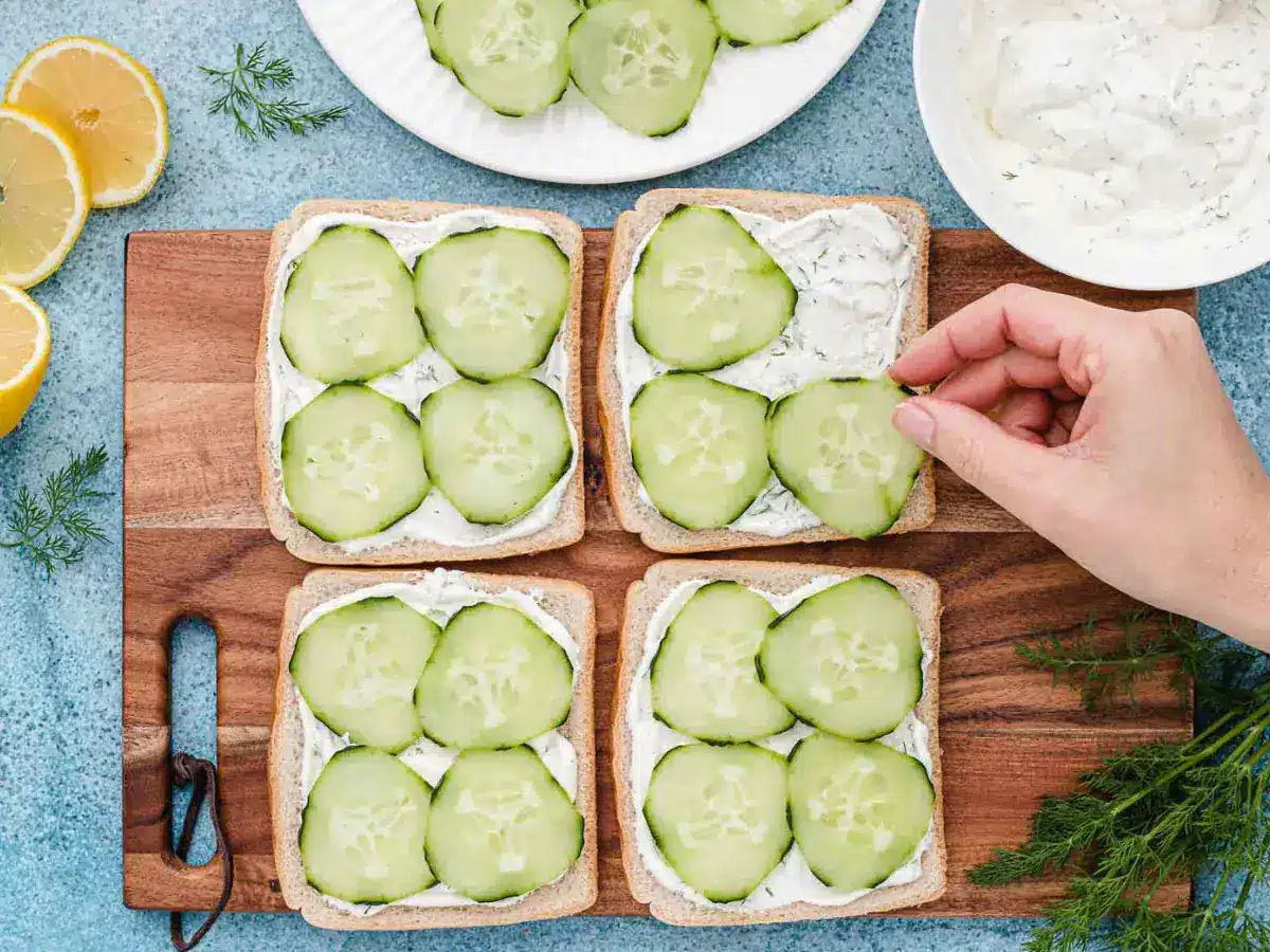 bread with cucumbers being placed