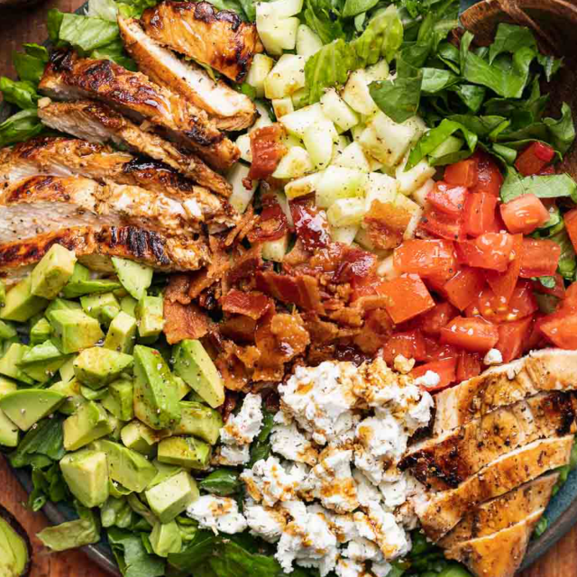 Grilled chicken salad on serving plate.