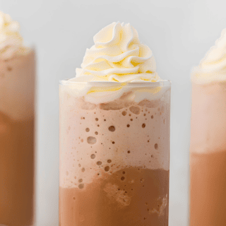 3 frozen coffees in glass cups with whipped cream