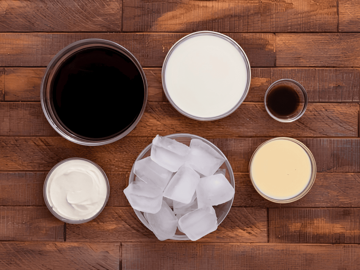 coffee, milk, condensed milk, vanilla extract, and ice in separate glass bowls