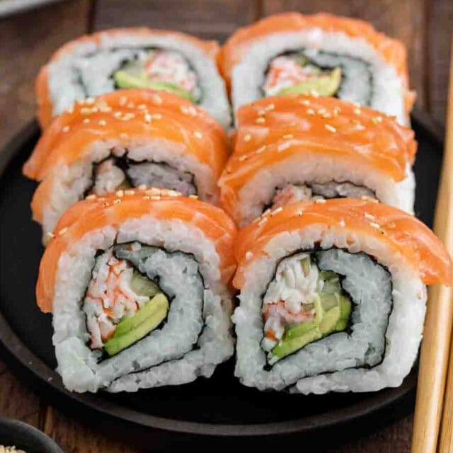 6 pieces of Alaska sushi on plate with chopsticks