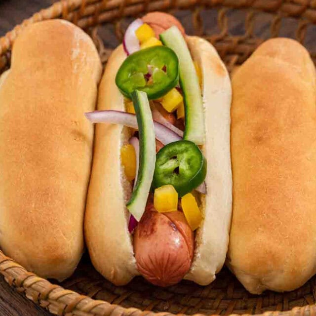 Plate with buns and one assembled hot dog
