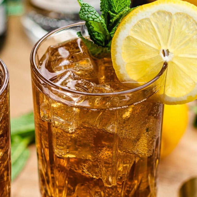 Long Island Iced Tea finished in glass with lemon wheel.