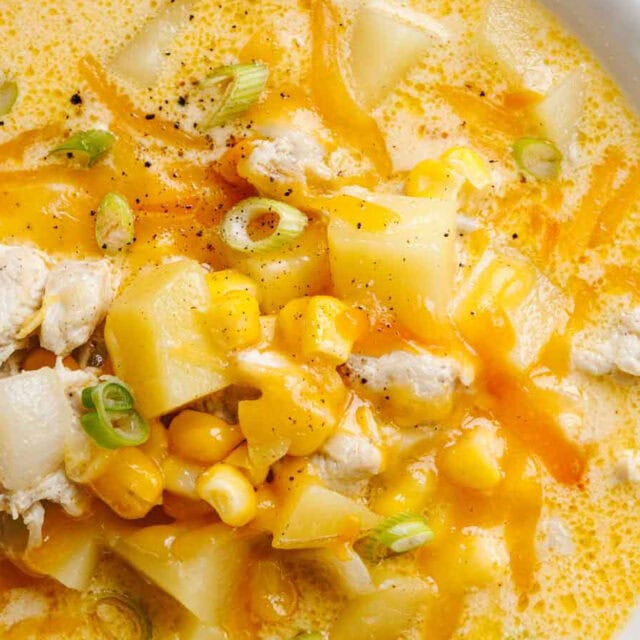 Bowl of chowder with corn and chicken.