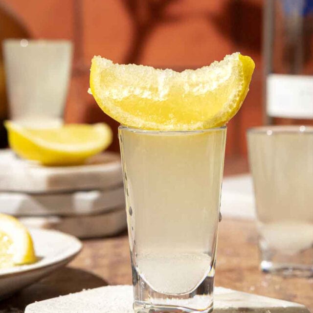 Lemon drop shooter with lemon wedge on top.