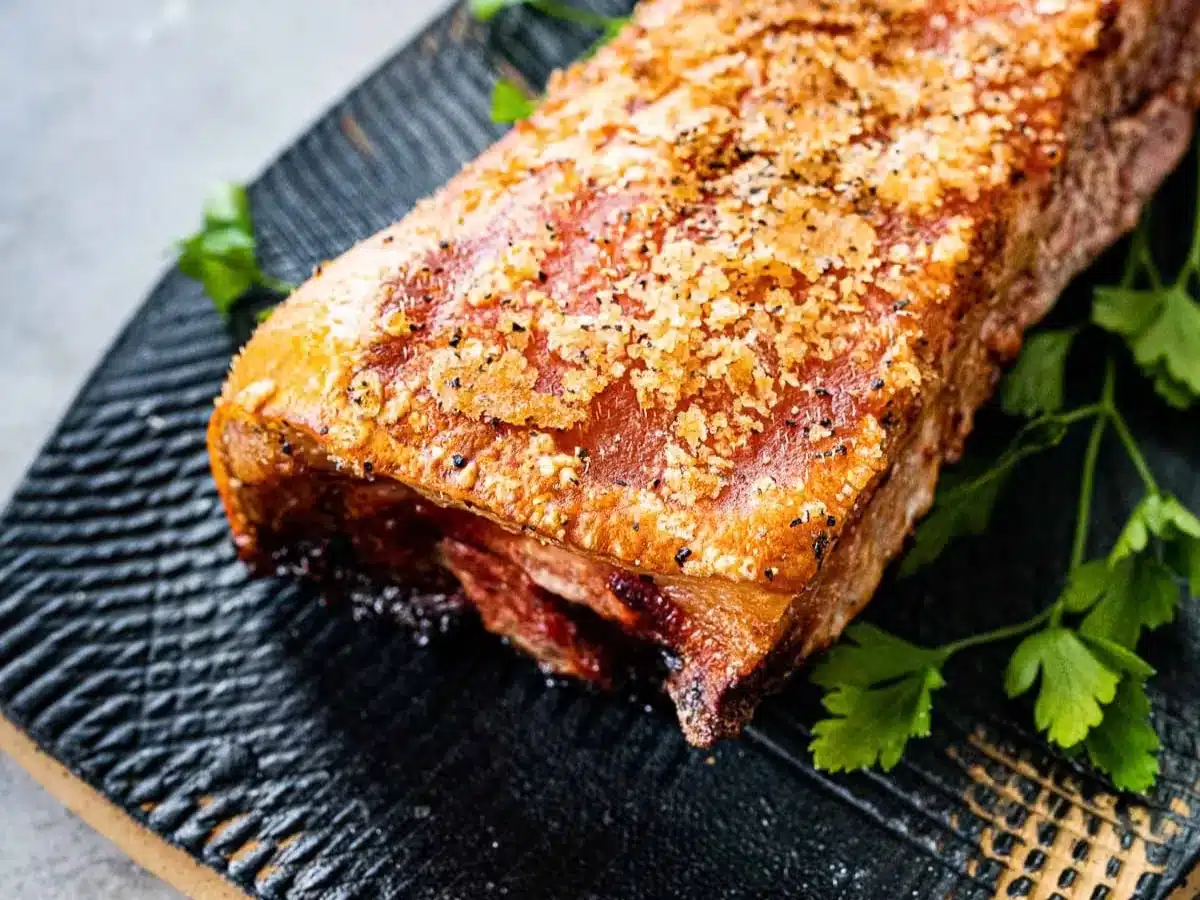 Large piece of meat with golden and crisp cooked fat.