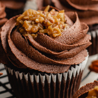 Chocolate cupcake with chocolate frosting on a wire rack