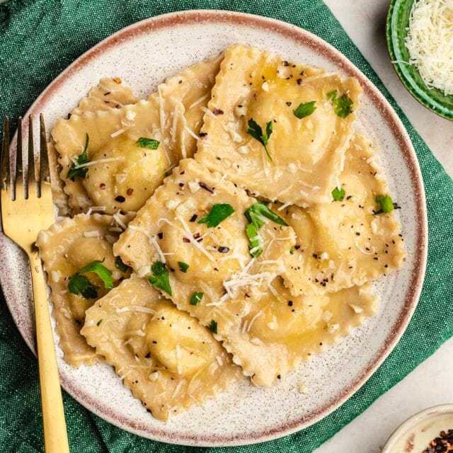 Ravioli with cheese and parsley, on dinner plate.