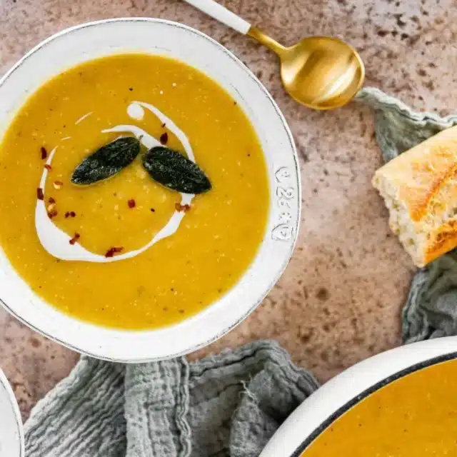 soup with a piece of bread and a spoon