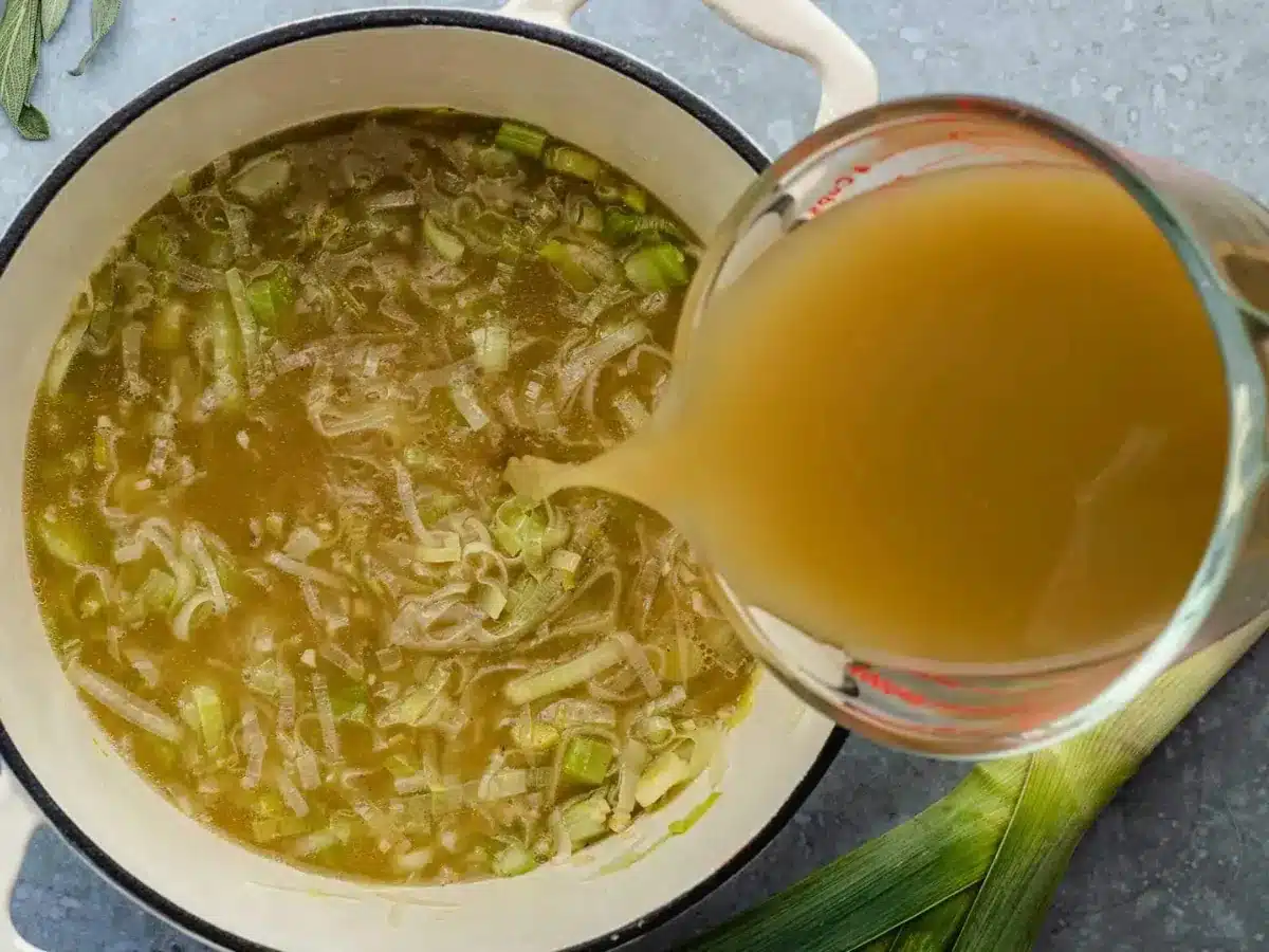 adding broth to soup 