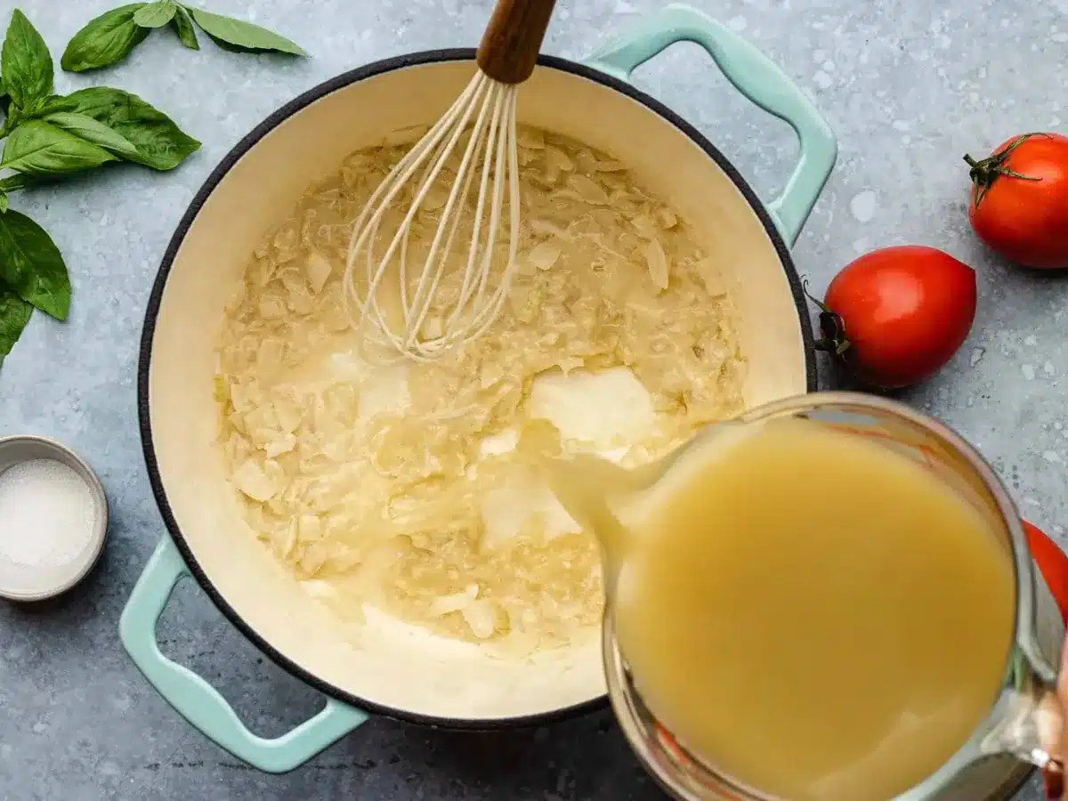 adding broth to a pot 