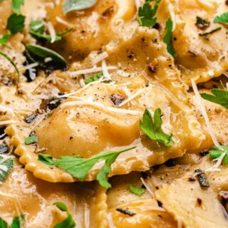 Ravioli topped with parmesan and brown butter sauce