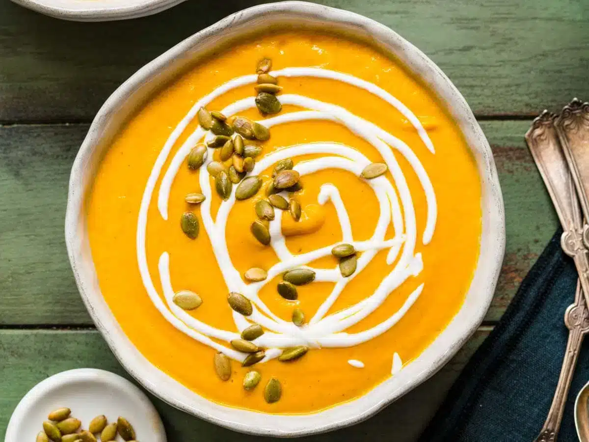 soup finished with cream and topped with seeds 