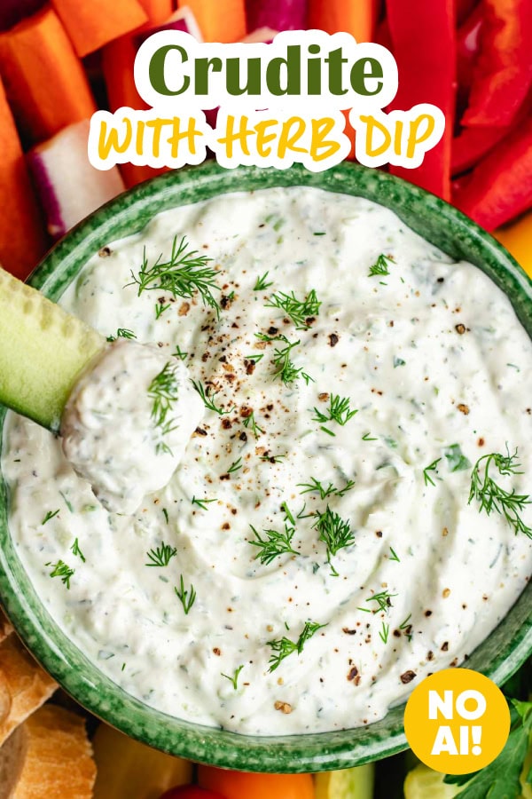 Dipping cucumber spear into herb dip