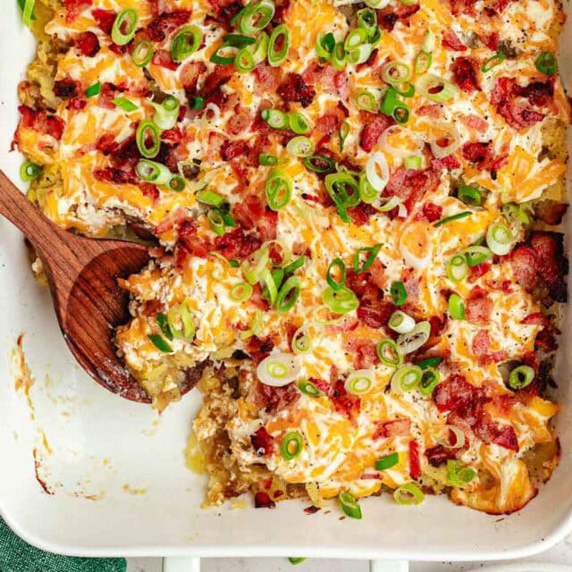 Finished potato casserole with wooden serving spoon