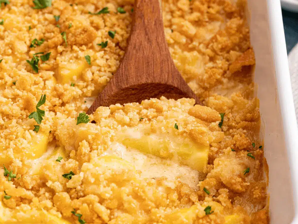 wooden spoon taking casserole 