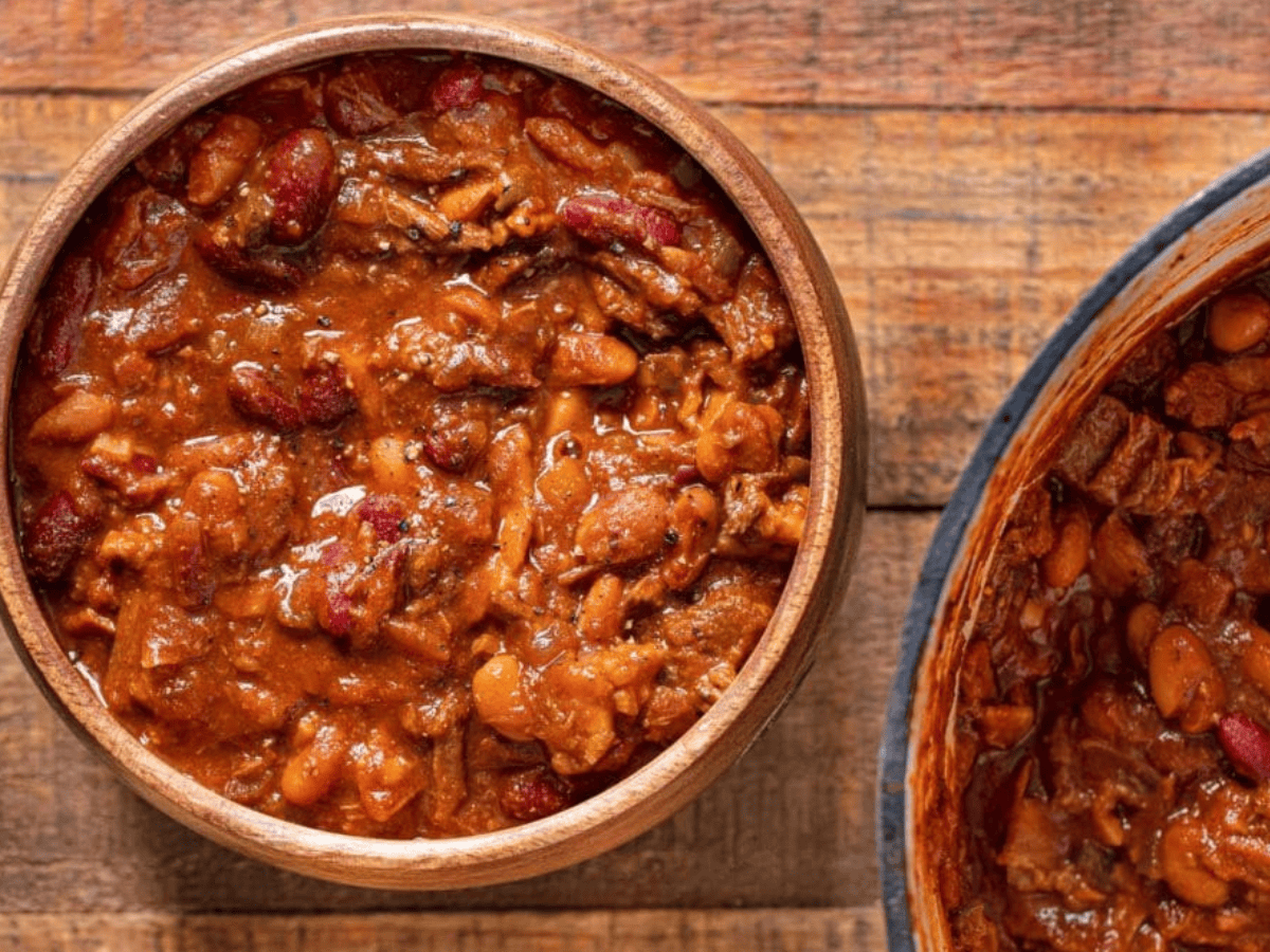 Beans served in bowl with pot on side