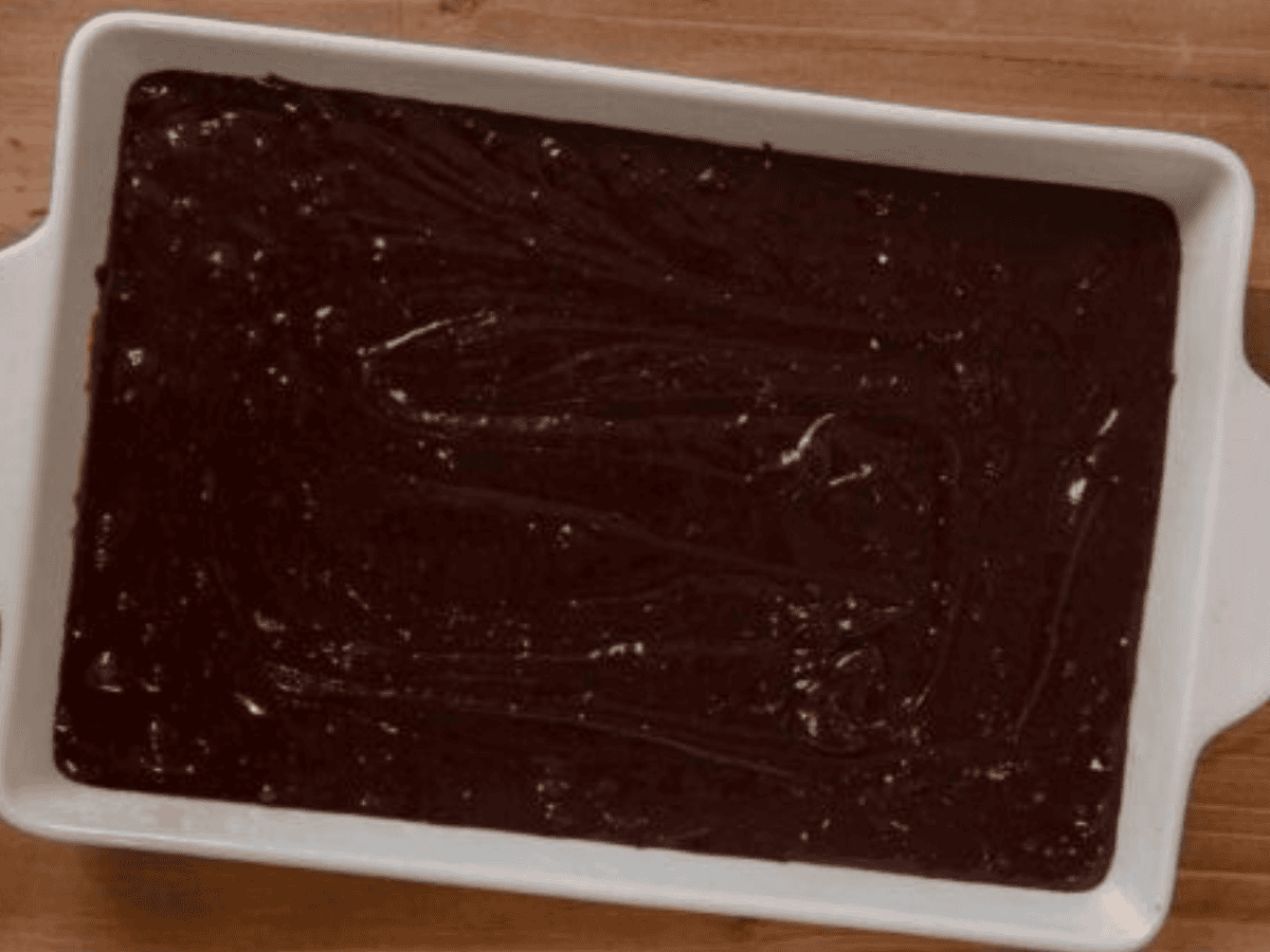 Frosted cake in white cake pan