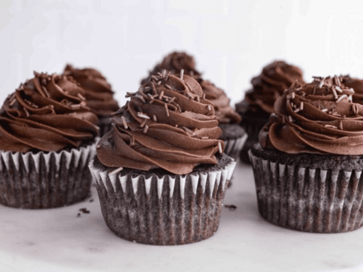 Cupcakes topped with frosting on cake stand