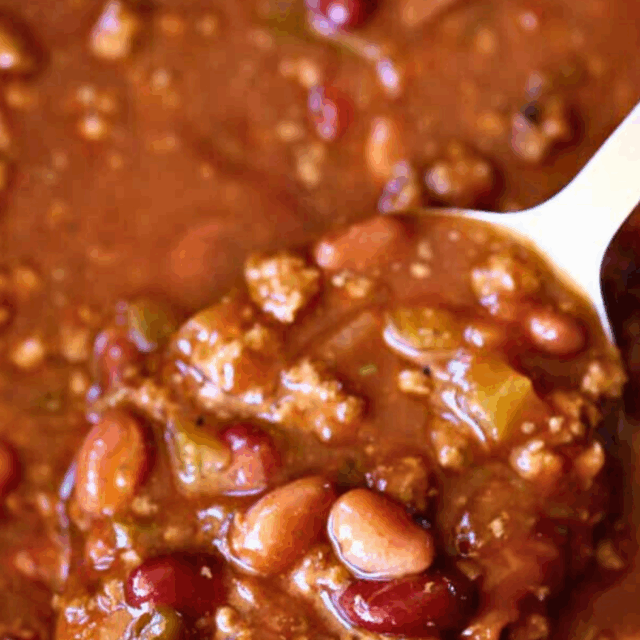 Closeup of chili in serving spoon.