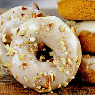 Frosted round dessert with nuts that is stacked and propped up in front