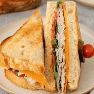 sandwich displayed on plate cut in half