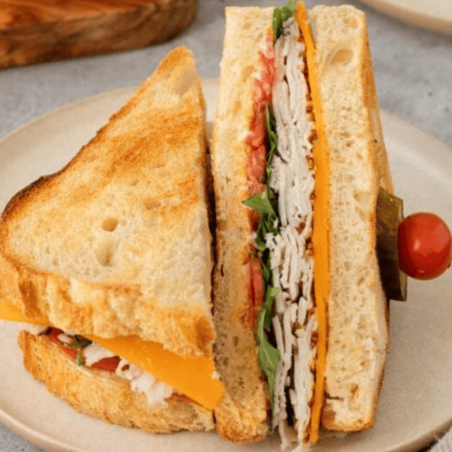 sandwich displayed on plate cut in half