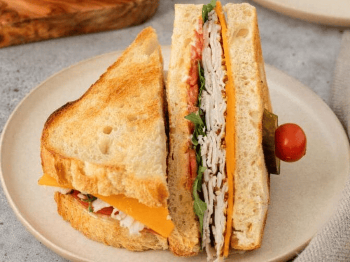 sandwich displayed on plate cut in half