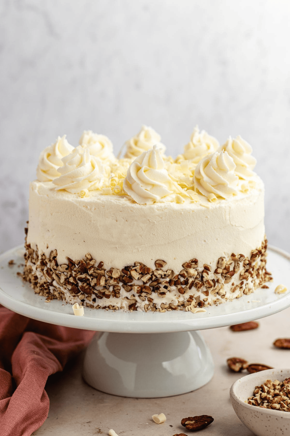 Cake on a cake stand with frosting swirls
