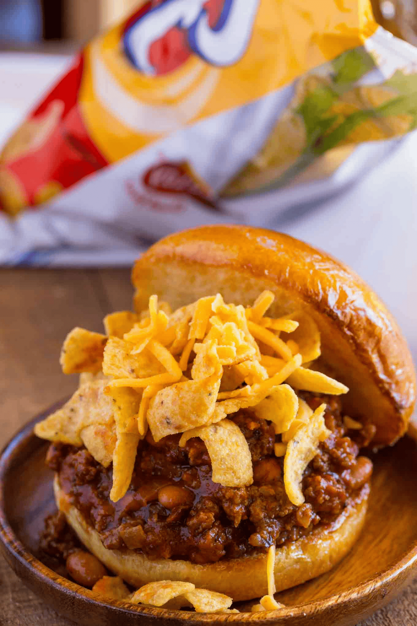 Meat sandwich topped with frito chips