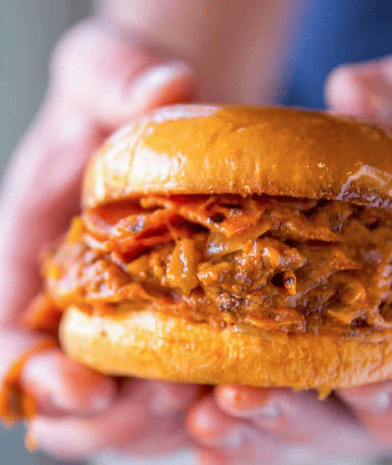 Hands holding meaty sloppy Joe recipe