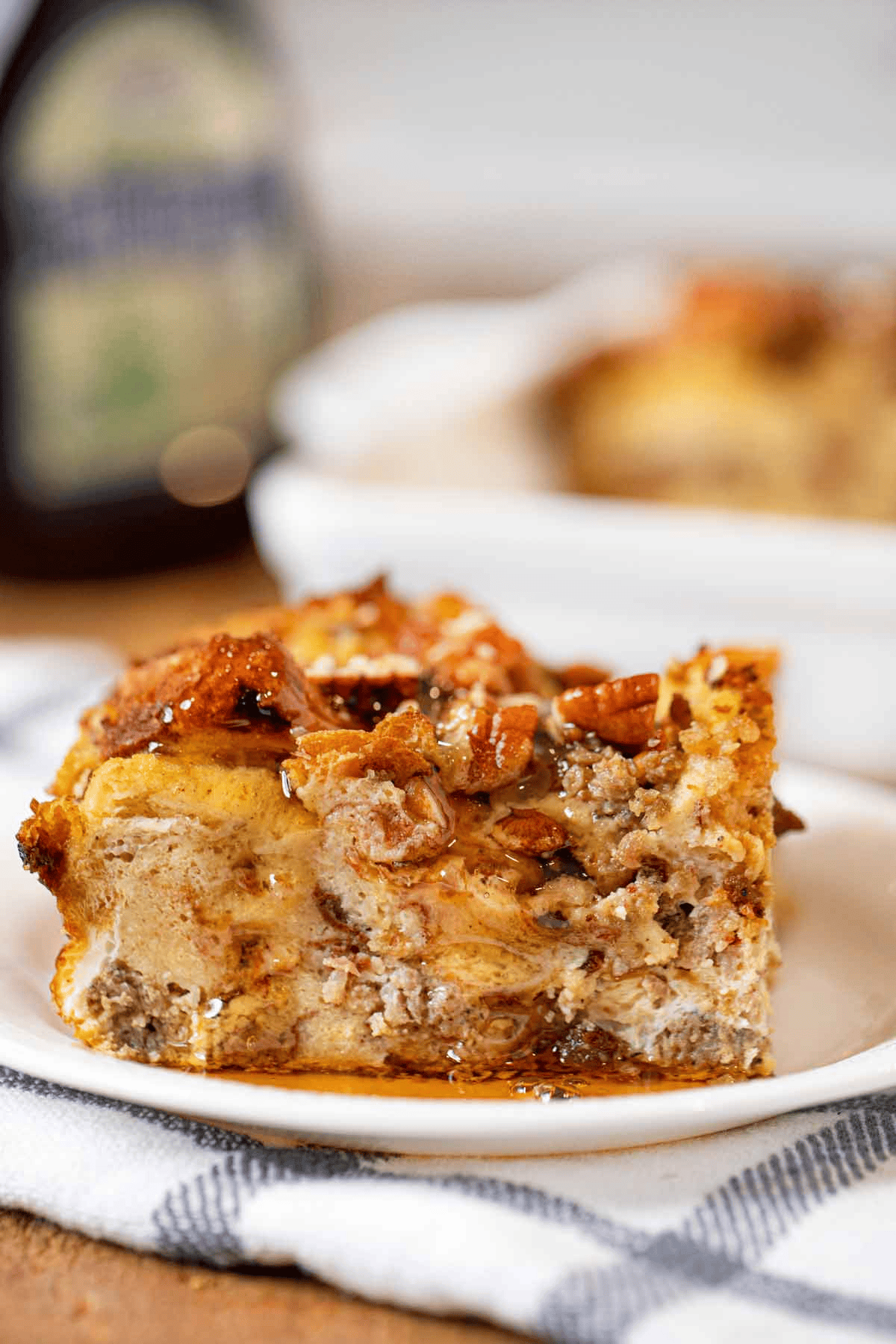 Slice of french toast bake on a plate topped with maple syrup