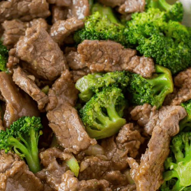 Close up of cooked beef pieces and broccoli in sauce