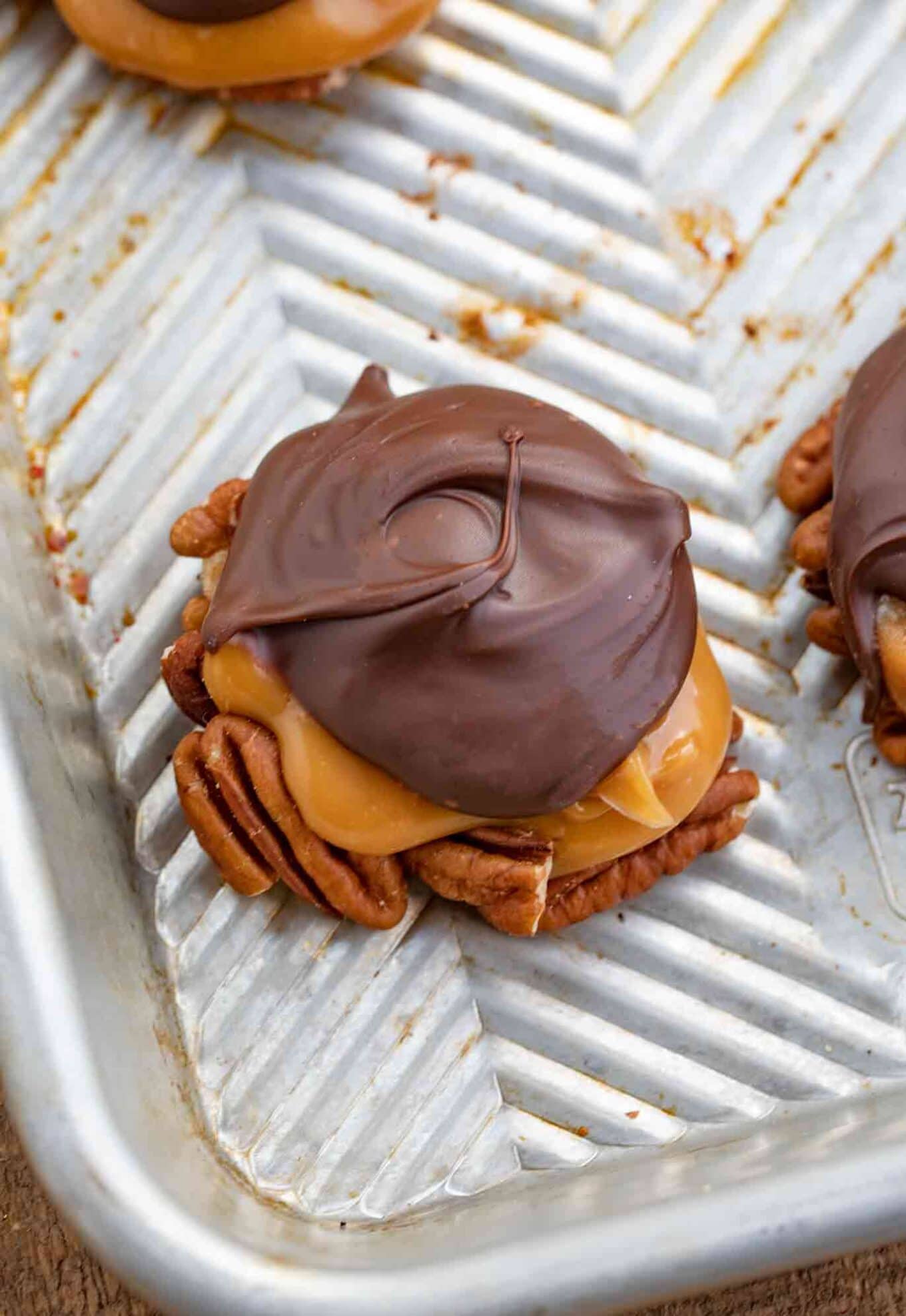 Chocolate and caramel candies on a baking sheet