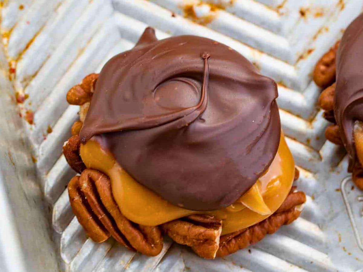 Homemade chocolate and caramel candy on a metal baking sheet