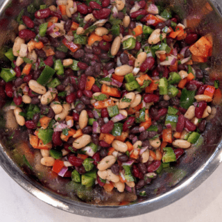 silver mixing bowl with mixed bean salad