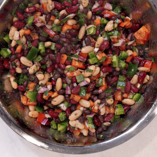 silver mixing bowl with mixed bean salad
