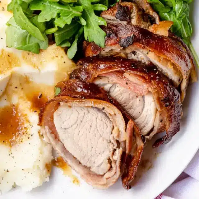 Dinner plate with roasted meat, mashed potatoes, and salad.