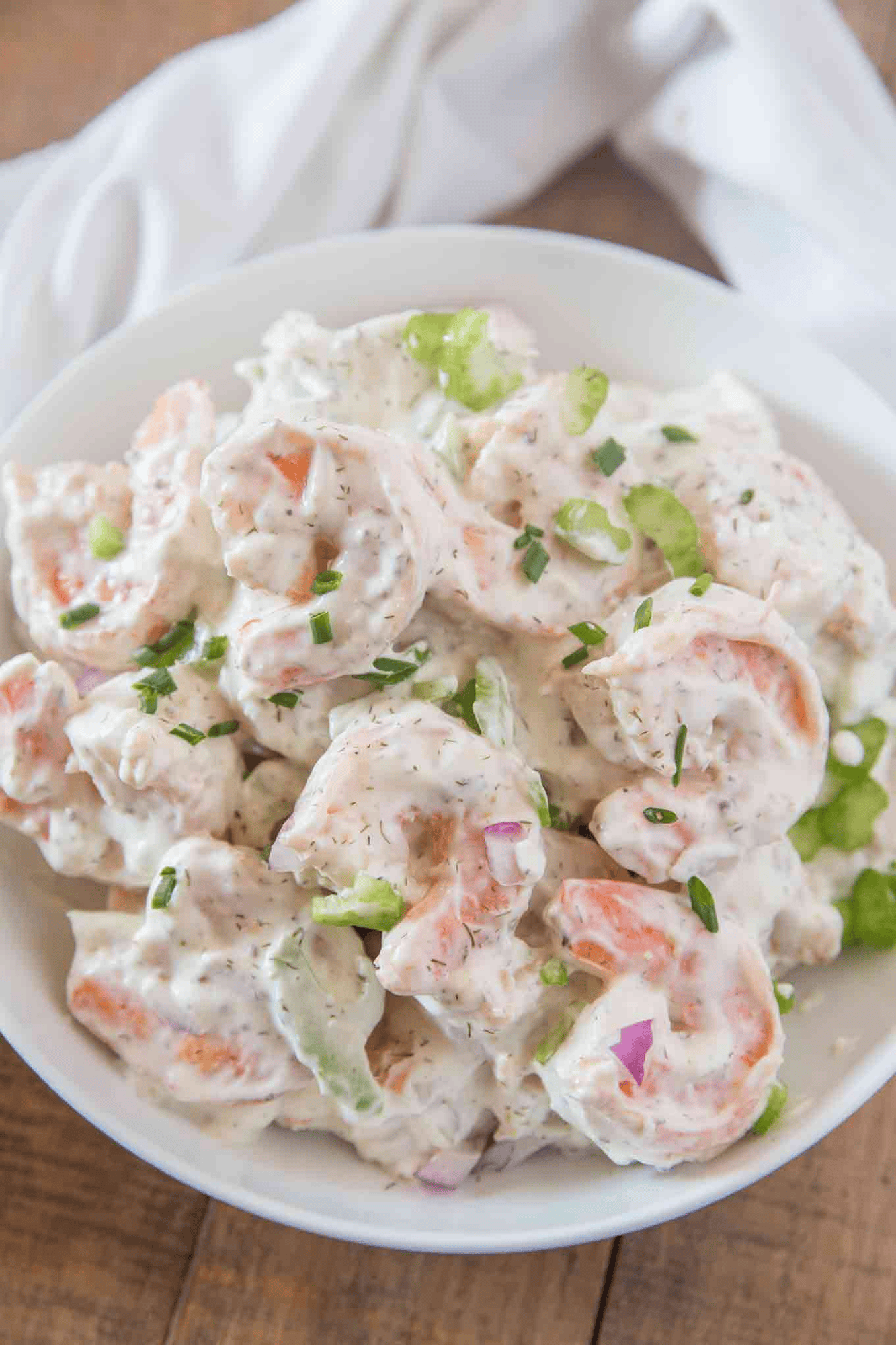 Creamy seafood salad served in a white bowl