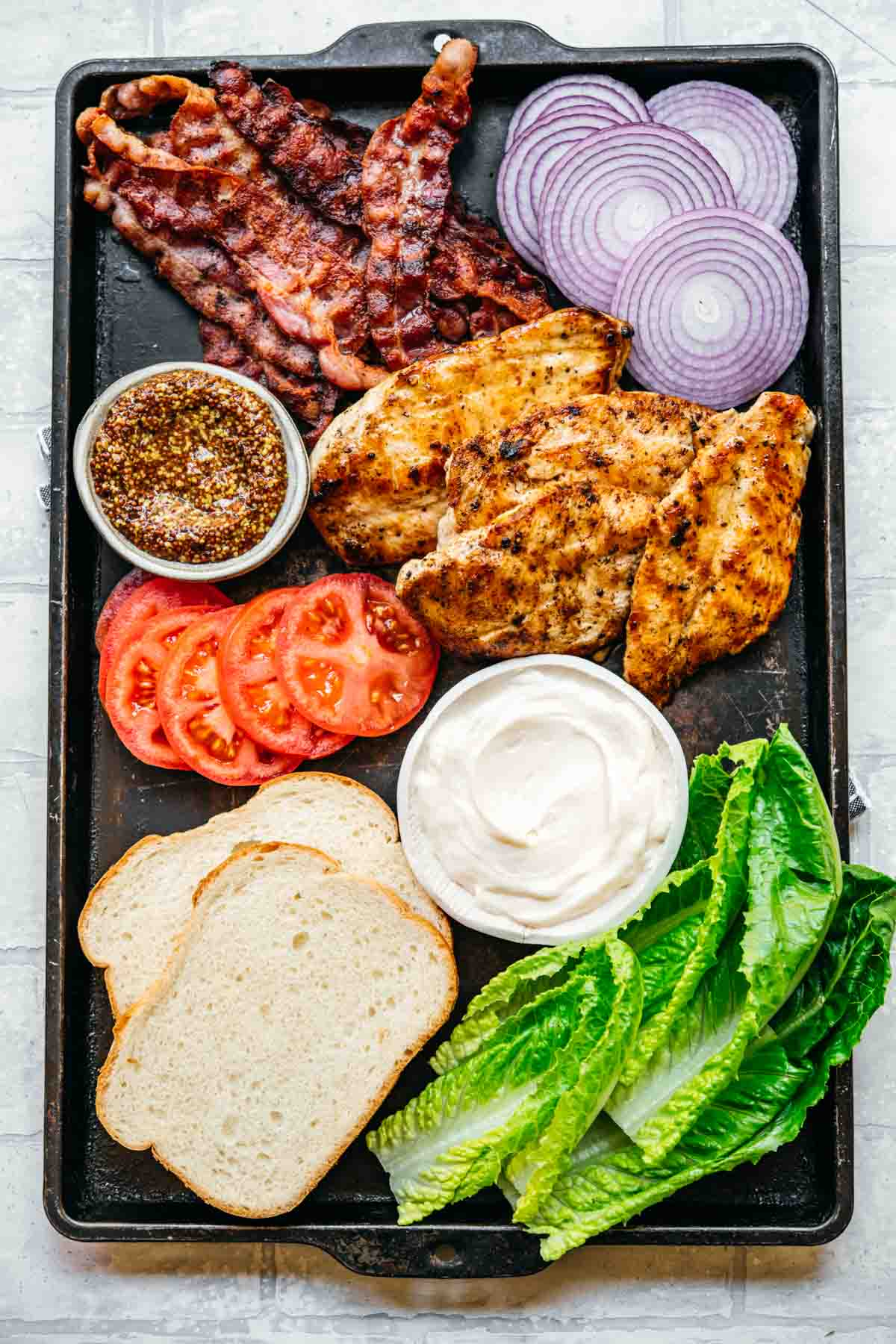 Unassembled sandwich ingredients on a pan