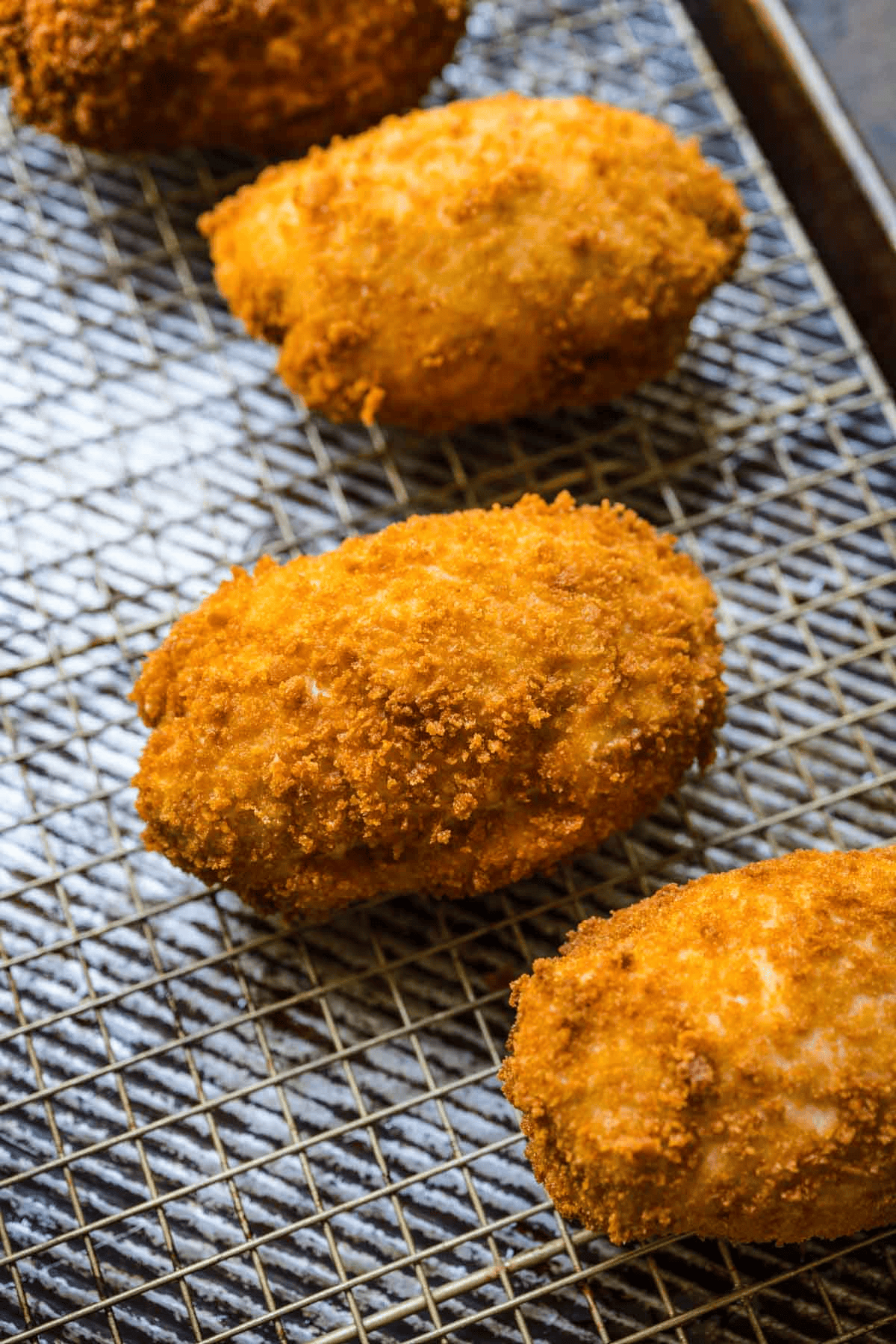 Breaded chicken pieces on a wire wrack
