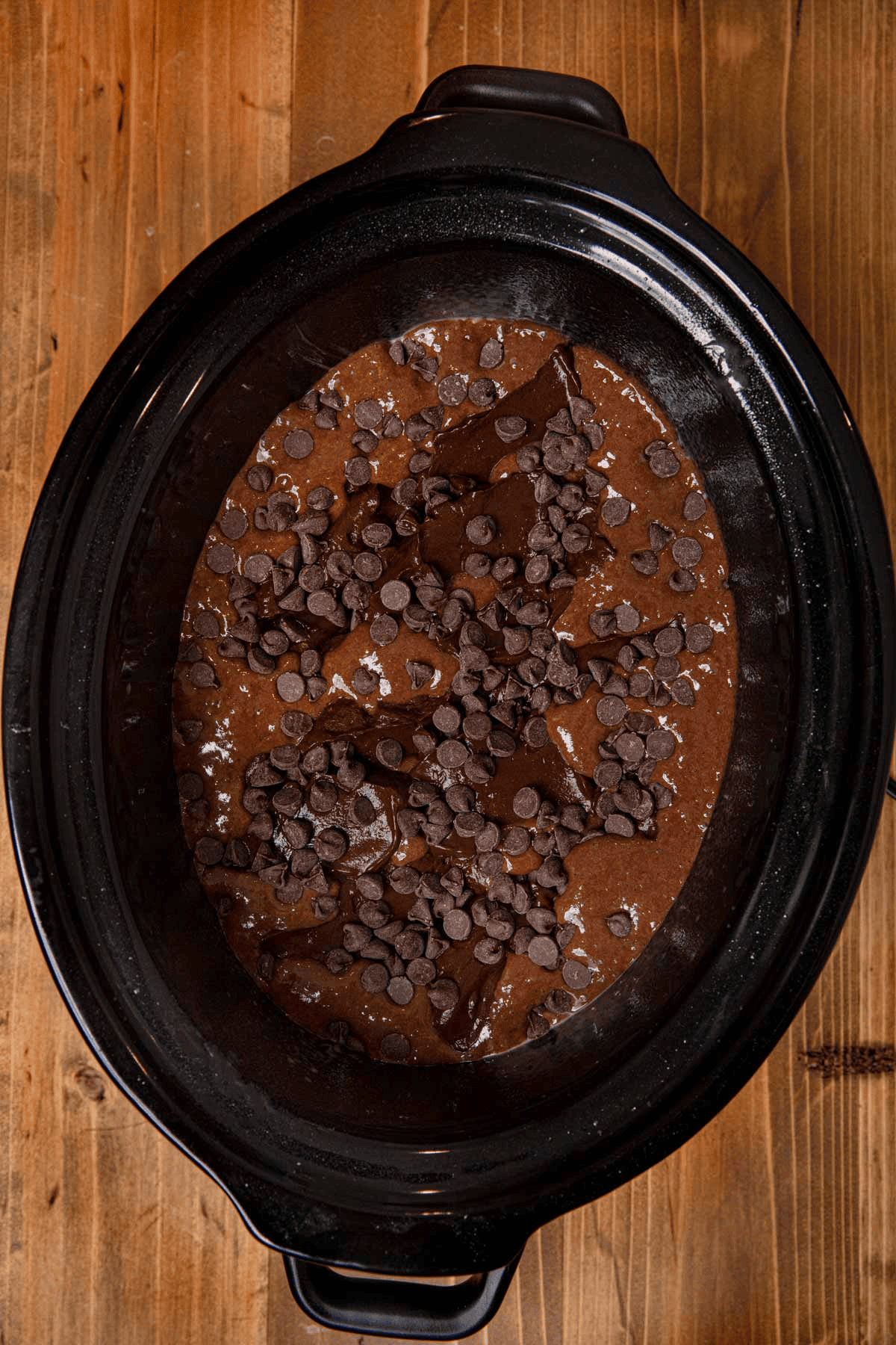 Chocolate batter and chocolate chips in a slow cooker